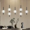 LED-riippuvalaisin Abeona, pituus 105 cm, musta metalli, 7-lamppuinen.